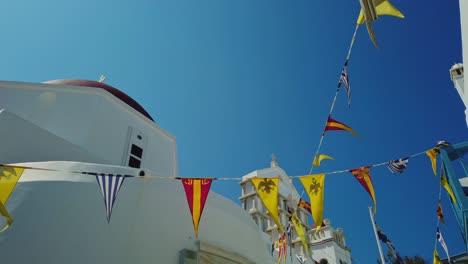 Greek-Orthodox-flags-during-Easter-at-church-in-Mykonos,-Greece