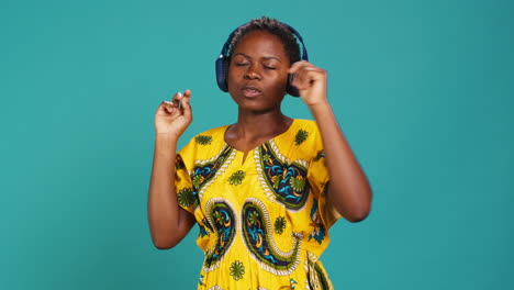 Carefree-relaxed-woman-listening-to-music-and-dancing-in-the-studio