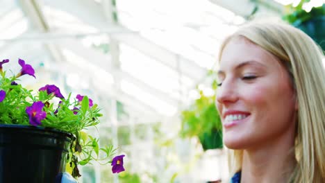 beautiful woman carrying flower plant