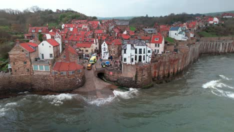 Scenic-Robin's-hood-bay-landmark-village-rooftops-aerial-view-at-high-tide