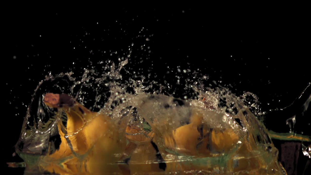 Yellow Bananas Splashing into Water in Super Slow Motion