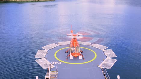 Oblique-angle-of-a-helicopter-lifting-off-from-a-ship-helipad-near-Bahia-Tictoc-in-Northern-Patagonia-in-Chile