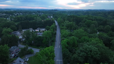 aerial shot of a long, straight road at sunset