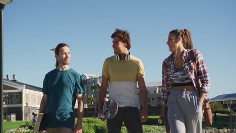 happy caucasian woman and two male friends spending time together on sunny day