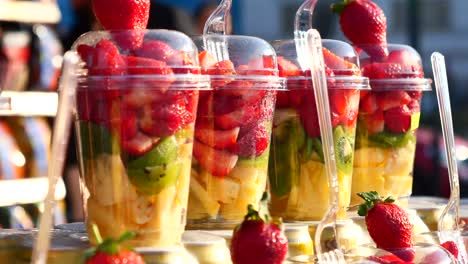 fresh fruit salad cups at a market