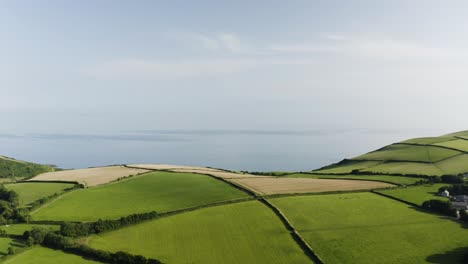 beautiful green rolling hills and atlantic blue ocean view in fowey, cornwall, uk