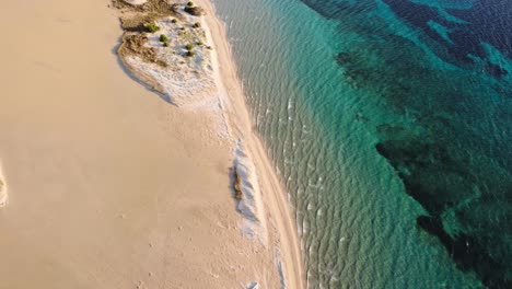 Crystal-clear-sea-aerial-view-of-Sardinia-beach-with-bright-sand,-aerial