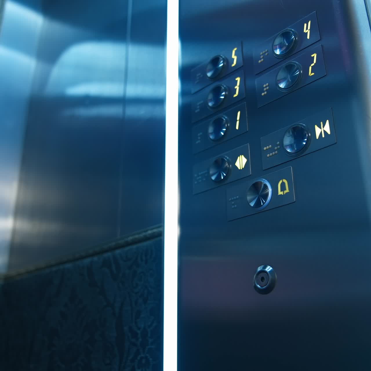 Man`s hand presses floor buttons in elevator. Unrecognizible man in suit pushes floor button. Selective focus