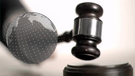 animation of spinning globe over hand using gavel