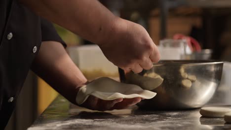 chef filling khinkali dumplings with minced meat, georgian traditional food