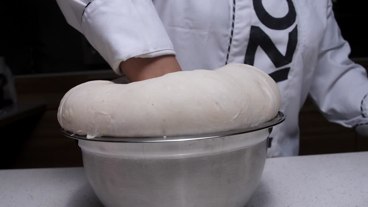 puting our hand in pizza dough