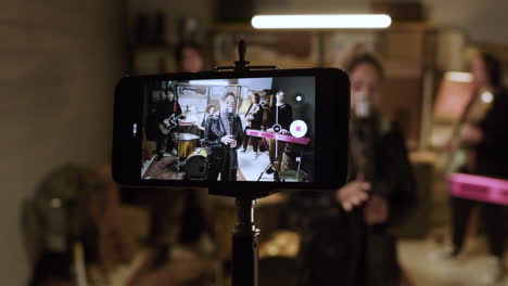 smartphone recording musical group in a studio