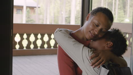 Loving-Mother-Hugging-And-Kissing-Her-Son-At-Home