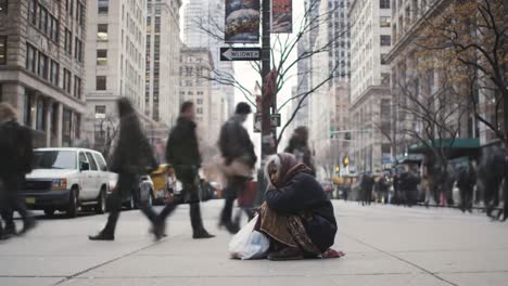 in a bustling urban area, a solitary person sits on the sidewalk with bags, while pedestrians walk past without noticing. the dynamic contrast highlights the issue of homelessness in the city.
