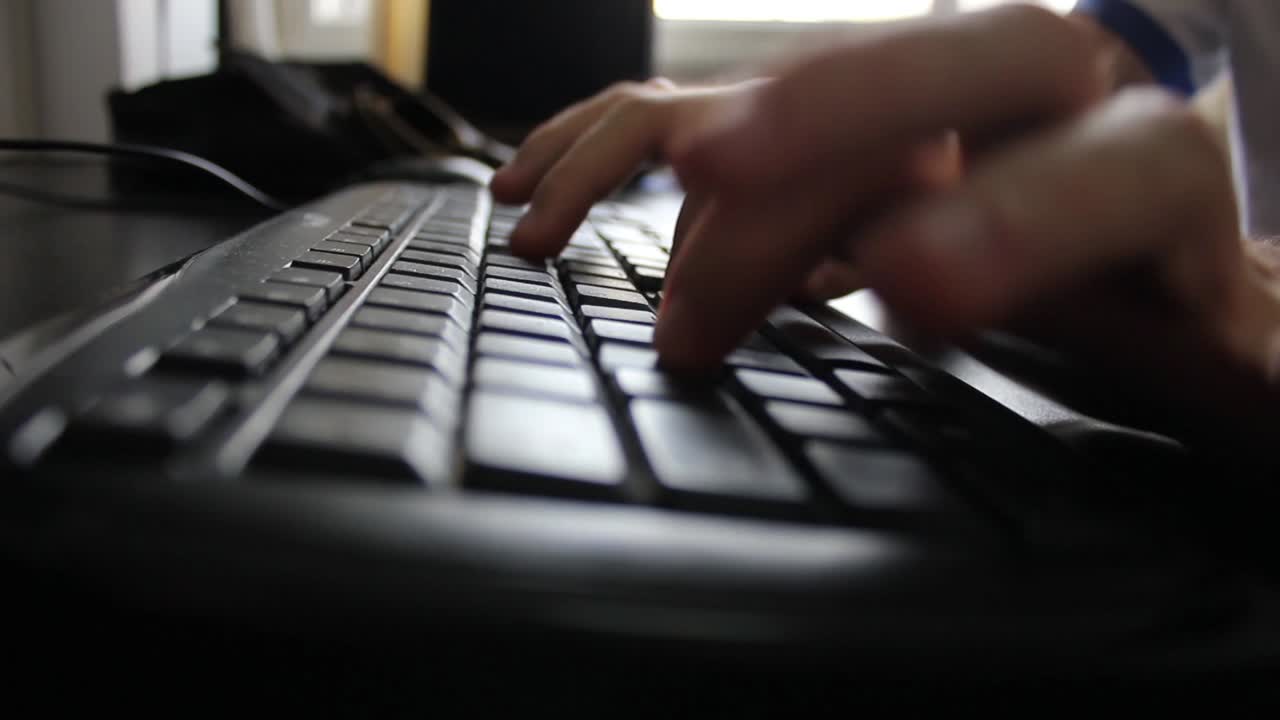 Close-up of Hands Typing on a Computer Keyboard