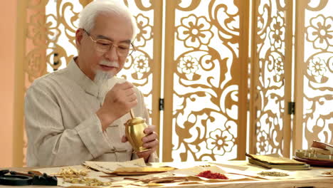 actual footage for an advertisement with the theme of traditional medicine, physician is selecting each dry medicinal herb to package the medicine