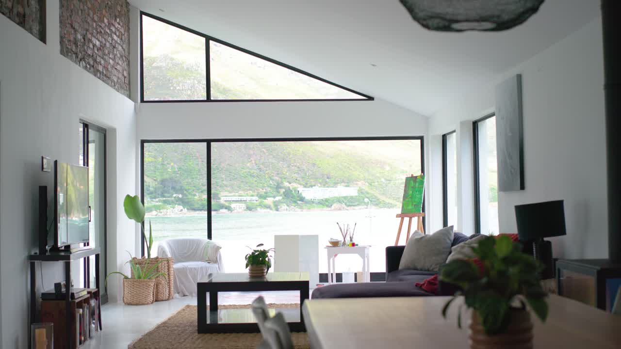 Coastal living room sofa is staying still while timer-triggered camera is capturing window view