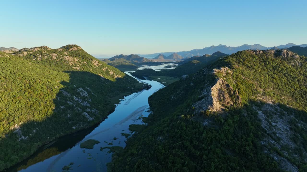Aerial: Lake Skadar with skyline during the day in the Montenegro mountains, orbit drone shot