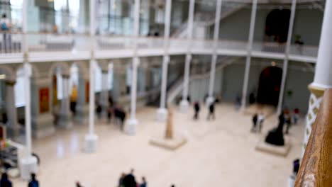 people exploring exhibits in spacious museum hall