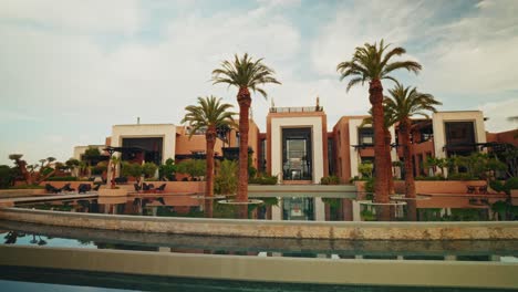 panoramic view of the exteriors of the fairmont royal palm resort in marrakesh. luxury hotel. refined exterior design. view of the outdoor swimming pools.
