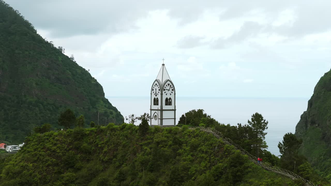 Aerial view of the picturesque Our Lady of Fatima Chapel nestled amidst the lush green mountains of Sao Vicente in Madeira, Portugal, showcasing the beauty of the landscape