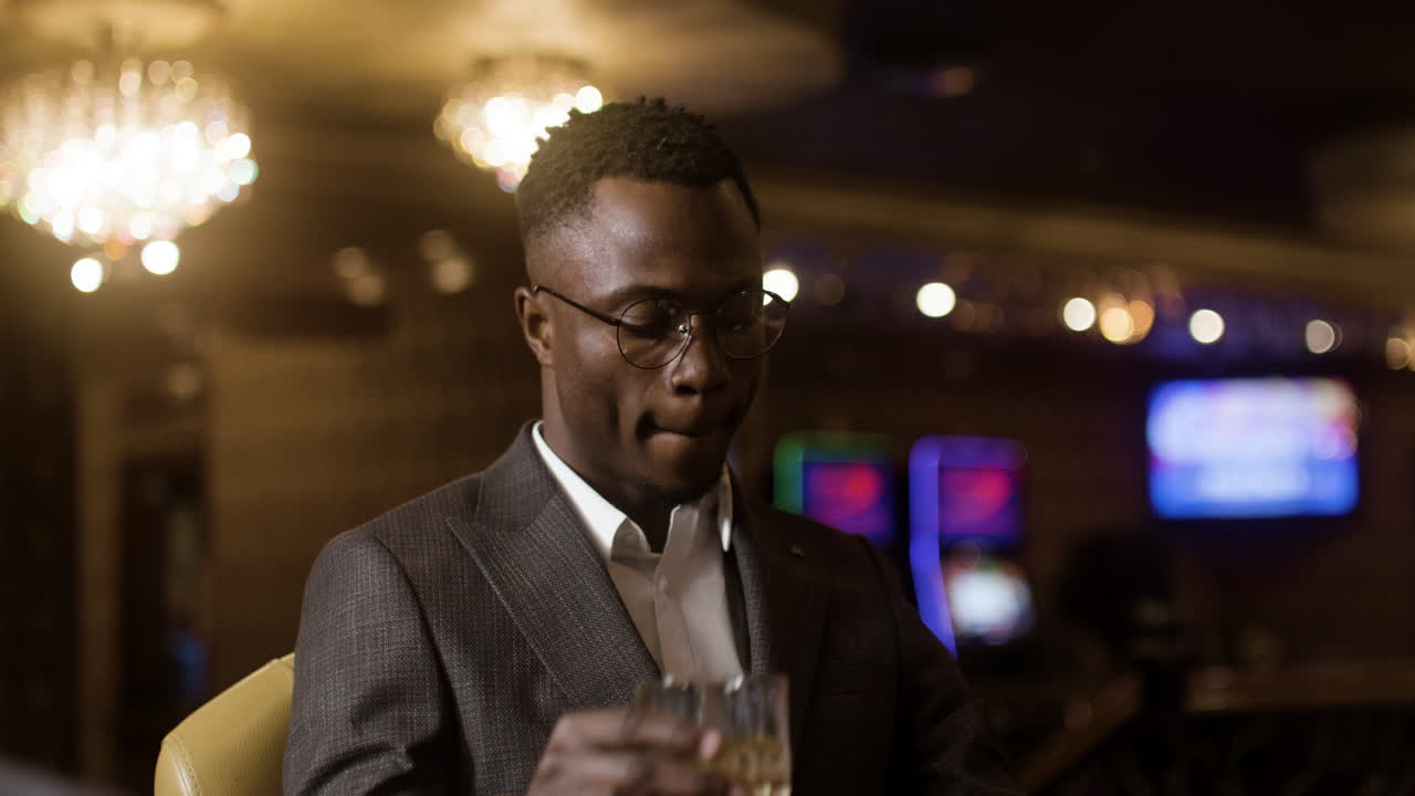 Man drinking at the poker table.