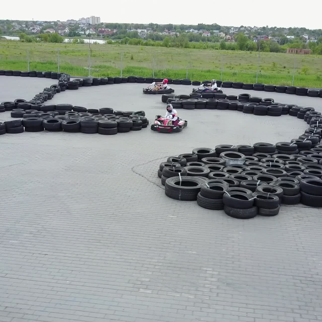 People Racing In Karts