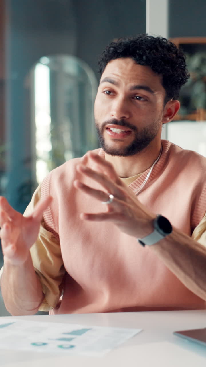 Young Man Talking and Gesturing During a Business Meeting