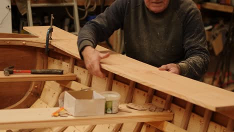 traditional boat building placing covering board on gunwale