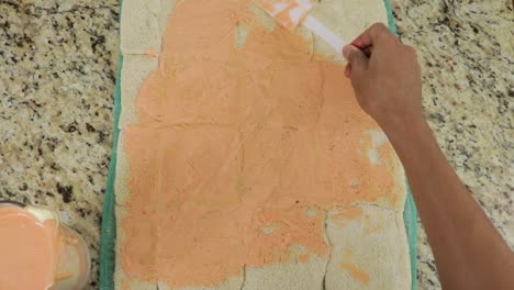 spreading creme on wraps dough, preparing wrapped children food