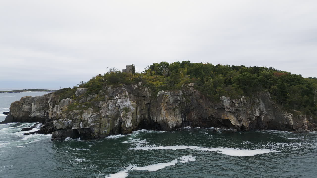Aerial View of a Rocky Coast with a Structure on Top of a Cliff