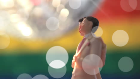 animation of light spots over male gay couple figurines