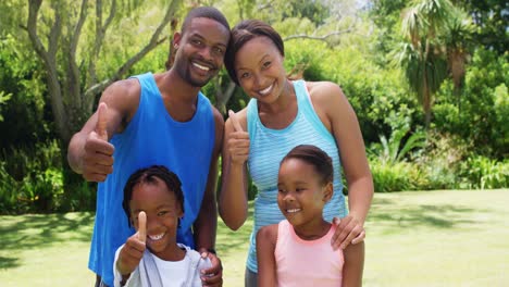 Family-posing-with-thumbs-up