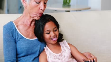 father playing with son on sofa in living room
