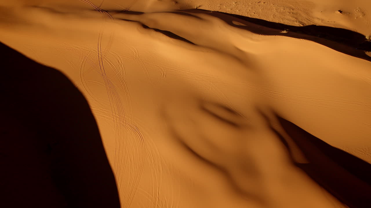 Floating above, the drone captures hypnotic pink hues and sculptural sand patterns of Utah’s dunes.