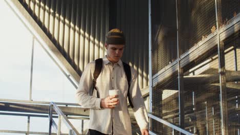 young man walking up stairs in industrial building