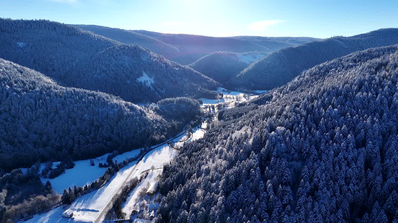 Aerial panoramic view of Vall&eacute;e de la Meurthe in Plainfaing Vosges during winter with snow and blue sky 4K