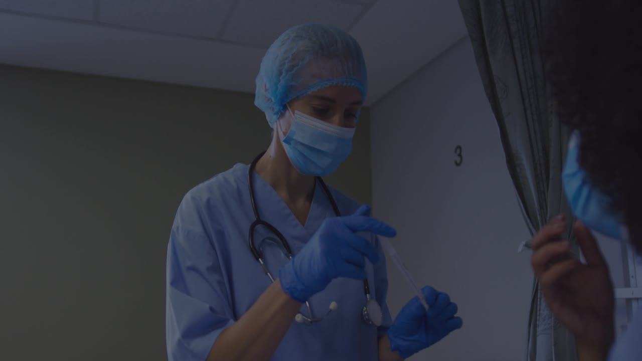 Medico che sistema lo stetoscopio, preleva il tampone nel cubicolo 3, esegue il campionamento mentre la sovrapposizione dei dati scorre