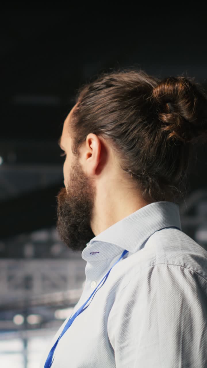 Vertical video Programmers on data center industrial platform checking code on tablet