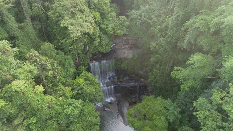 aerial view of a waterfall in a lush tropical forest