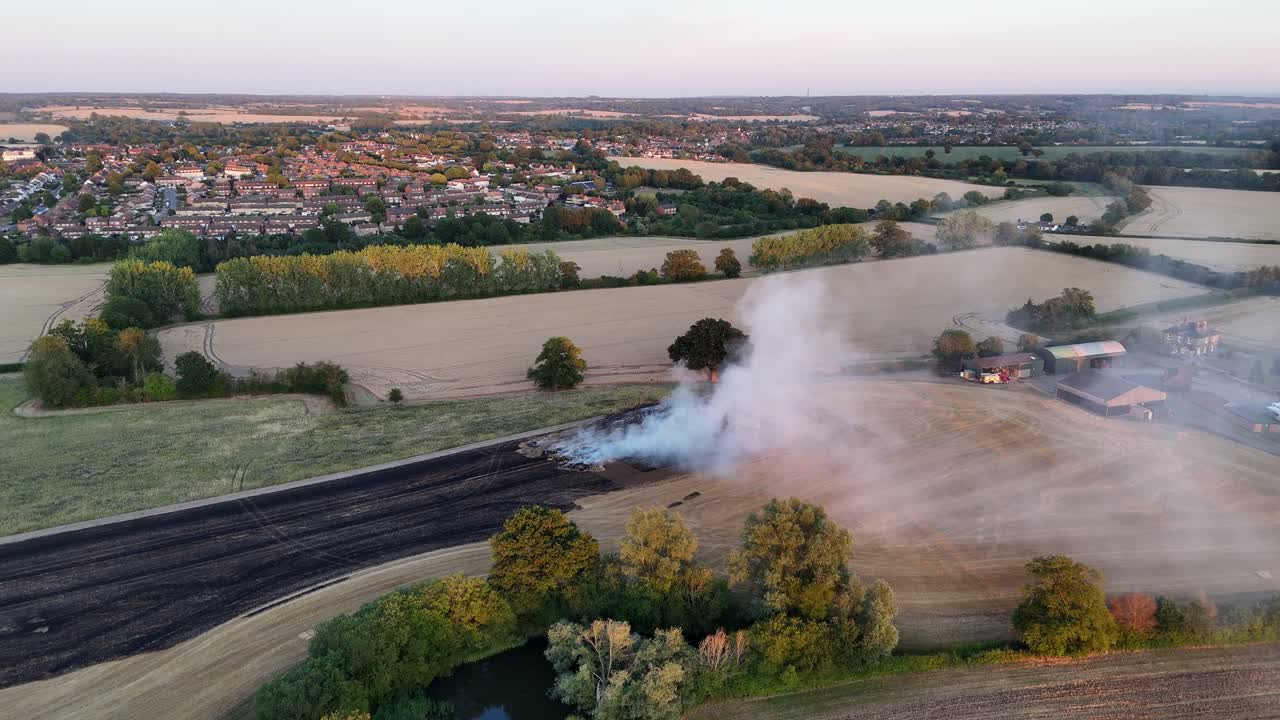 Farm Fields Fire smoking Essex UK warm glow of sunset drone,aerial