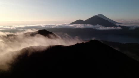 batur volcano on bali island at sunset - aerial drone shot