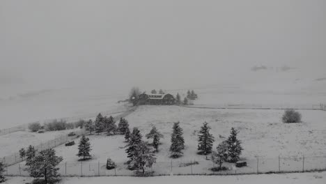 Flying-over-a-beautiful-log-home-in-the-middle-of-a-blizzard