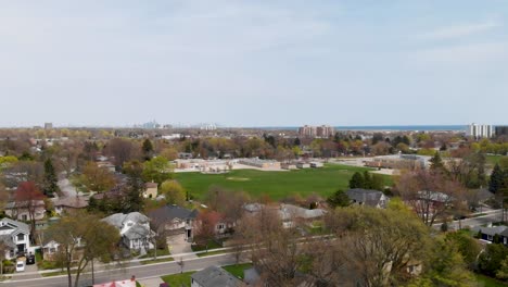 Dron-Recorriendo-El-Vecindario-De-Mississauga-Con-Un-Campo-Y-Una-Escuela-A-La-Vista