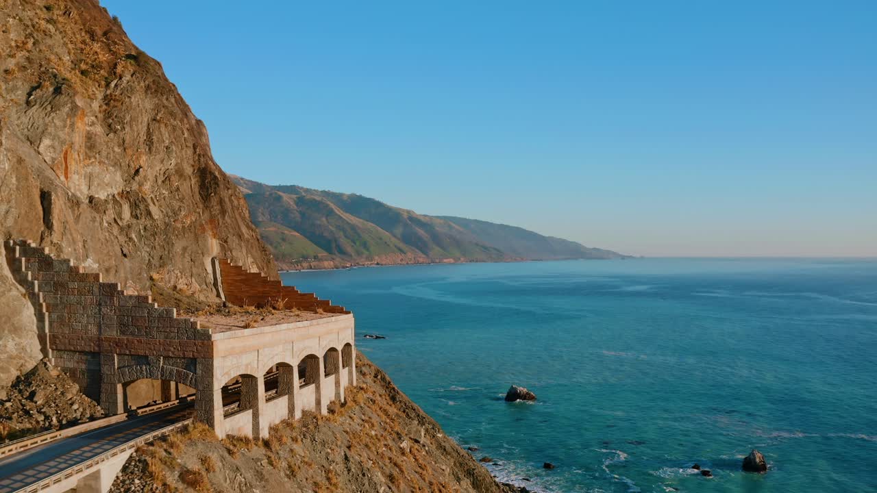 Aerial past the Rock Shed on Highway 1 in Central California. The Pacific Ocean can be seen in the background
