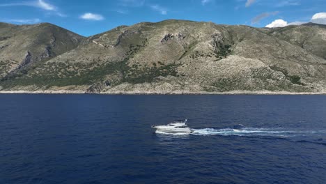 clear view of a luxurious yacht cruising the calm waters near the coast of shpella, albania