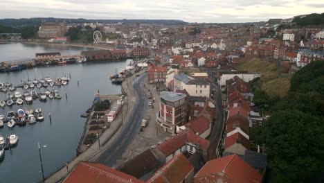 establishing drone shot over edge of scarborough and harbour on overcast day