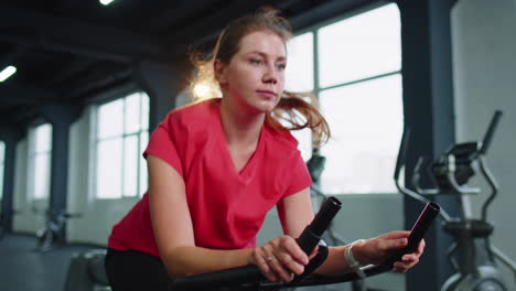 woman performs aerobic endurance training workout cardio routine on the simulators, cycle training