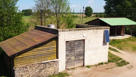 Weathered-rural-building,-integrated-energy-supply,-power-grid-and-solar-panels