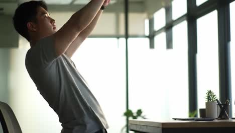 transitioning from sitting to standing: a young man's ergonomic journey in a modern office environment for improved posture and productivity